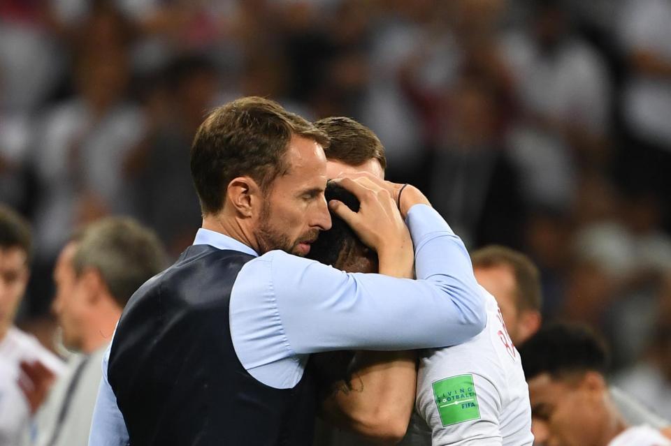  England boss Gareth Southgate comforts a tearful Marcus Rashford moments after the heartbreaking defeat