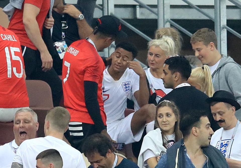  Jesse Lingard wipes away a tear surrounded by his loved ones