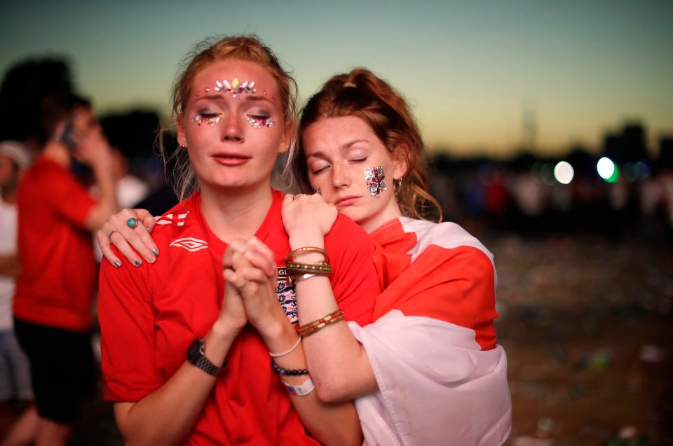  Gutted England fans comfort each other following the shattering semi-final loss