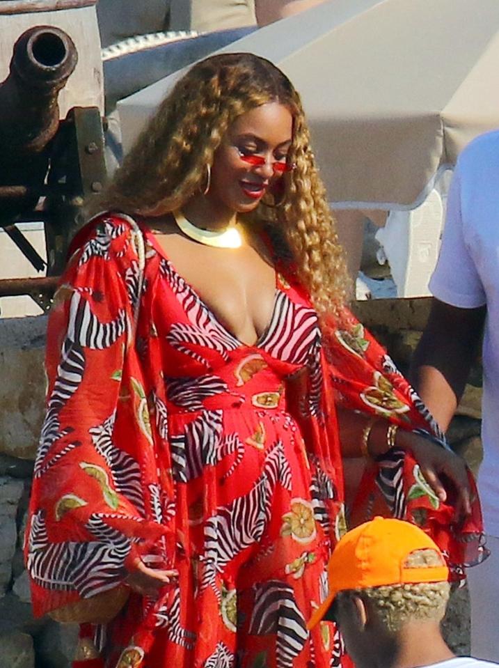  Beyonce wore her hair in curls and a pair of red frame sunglasses