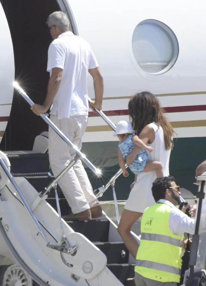  Clooney held on tightly to the railings as he climbed the steps to the private jet