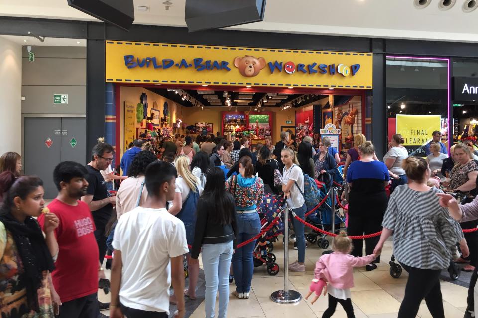  Shoppers queue outside the Build-A-Bear shop in Birmingham