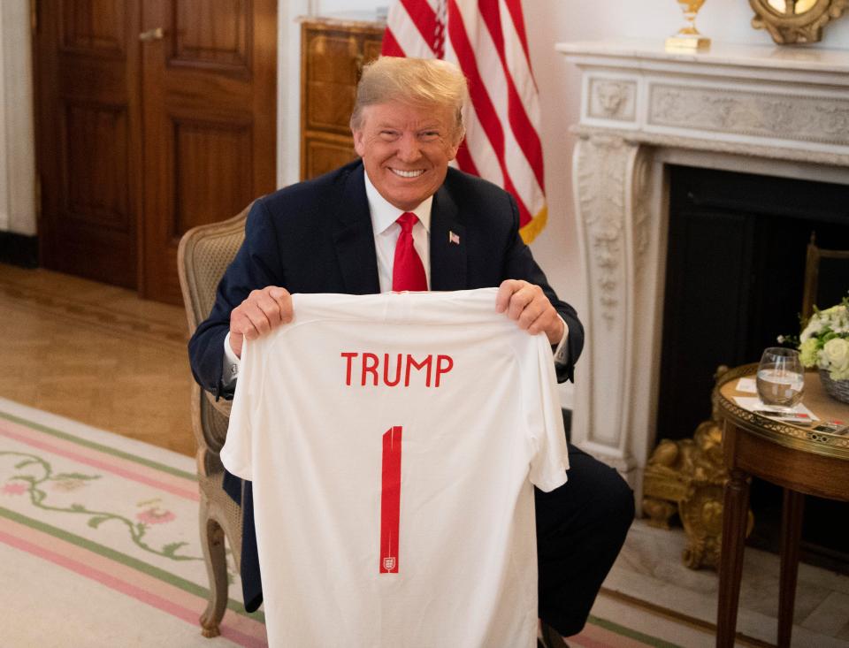  President Trump with an England shirt presented to him by The Sun