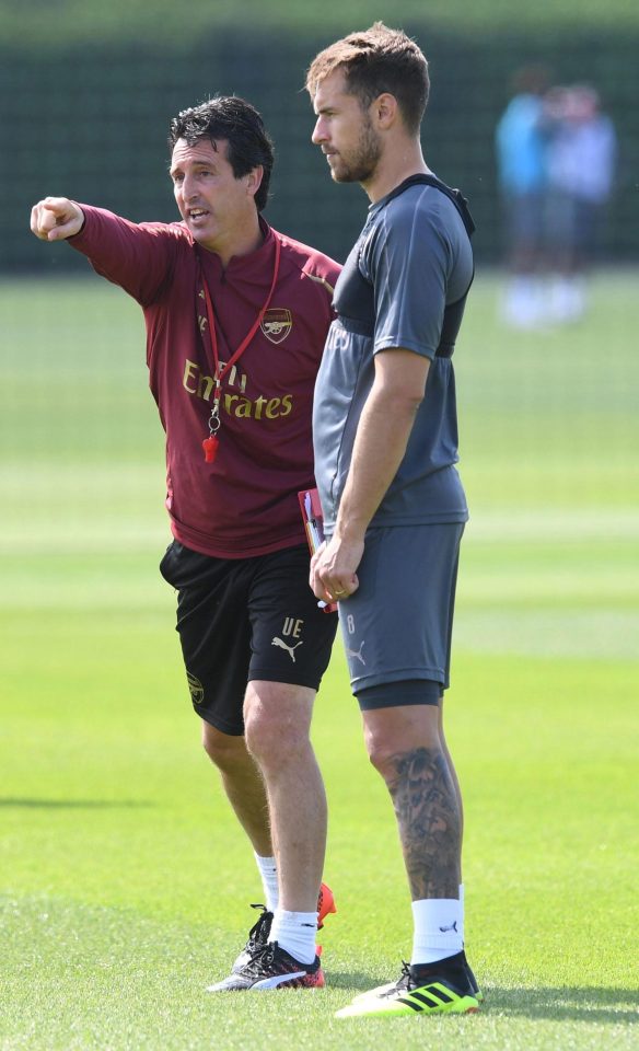  Unai Emery hands out instructions to Aaron Ramsay as the Gunners start pre-season training