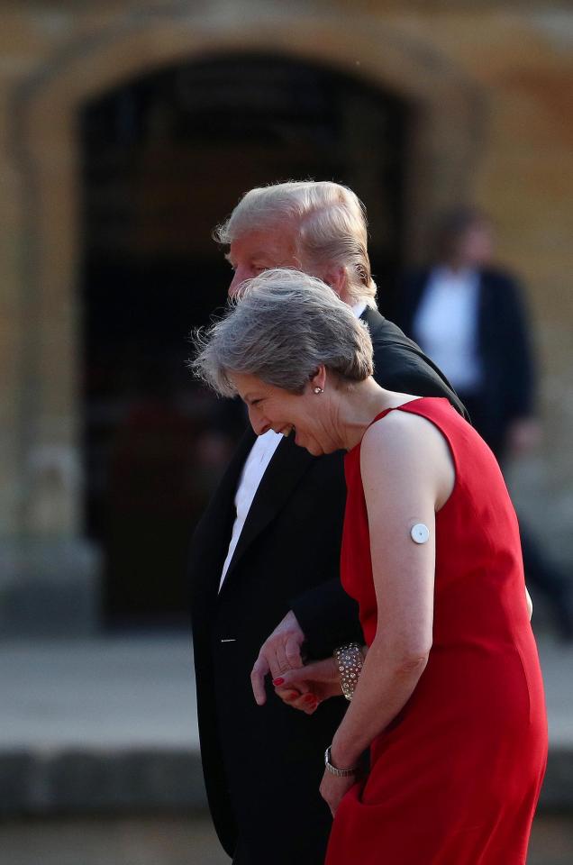  Theresa May and Donald Trump walk across the courtyard at Blenheim Palace, where they attended a dinner