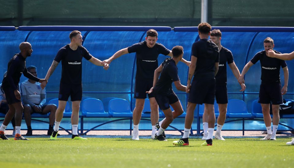  England fans held hands as they formed a barrier during the training session