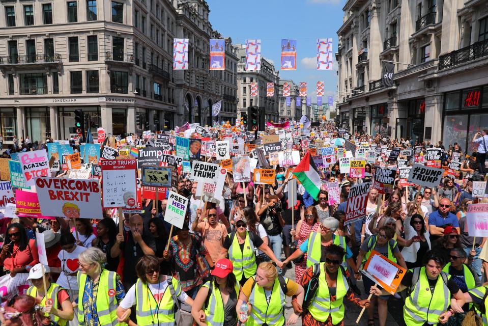  Protesters waving 'Dump Trump' banners march down Regent Street in central London this afternoon