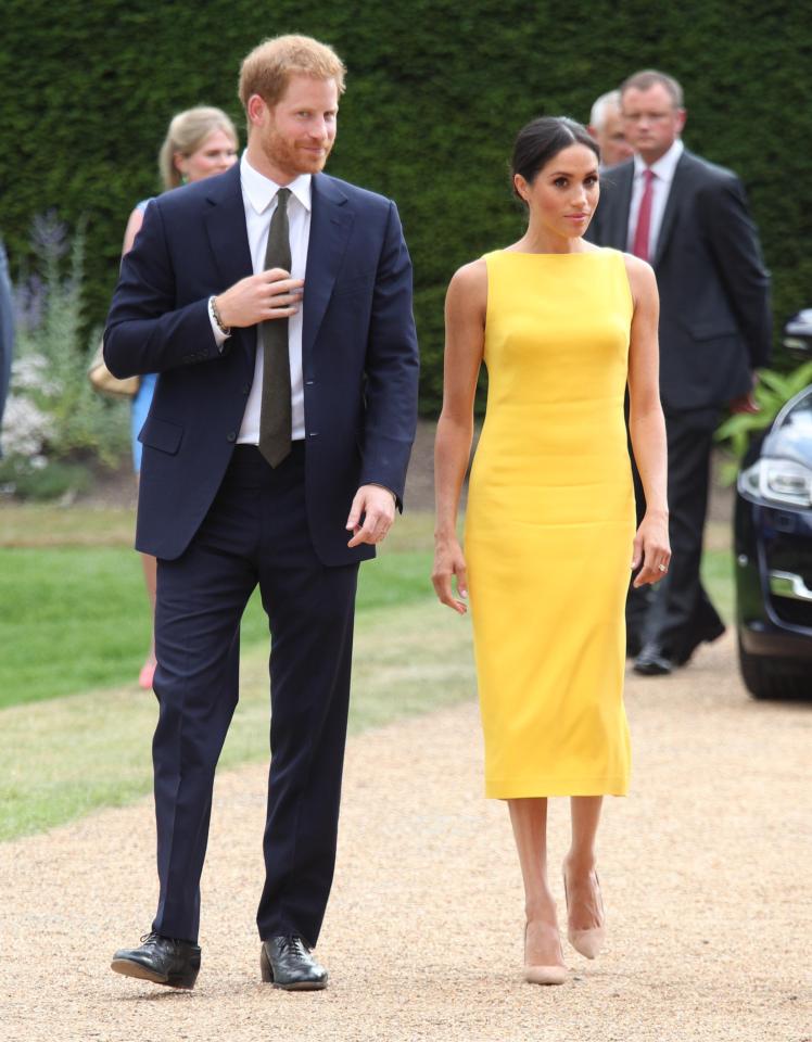  Meghan Markle stuns in yellow dress next to her husband