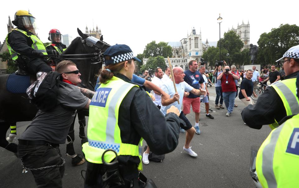  One man was seen swinging a bat around as another tried to hold him back just outside the Houses of Parliament