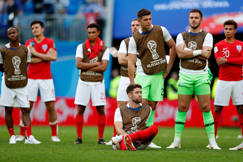  The England players looked distraught as they watched Belgium collect their third place medals