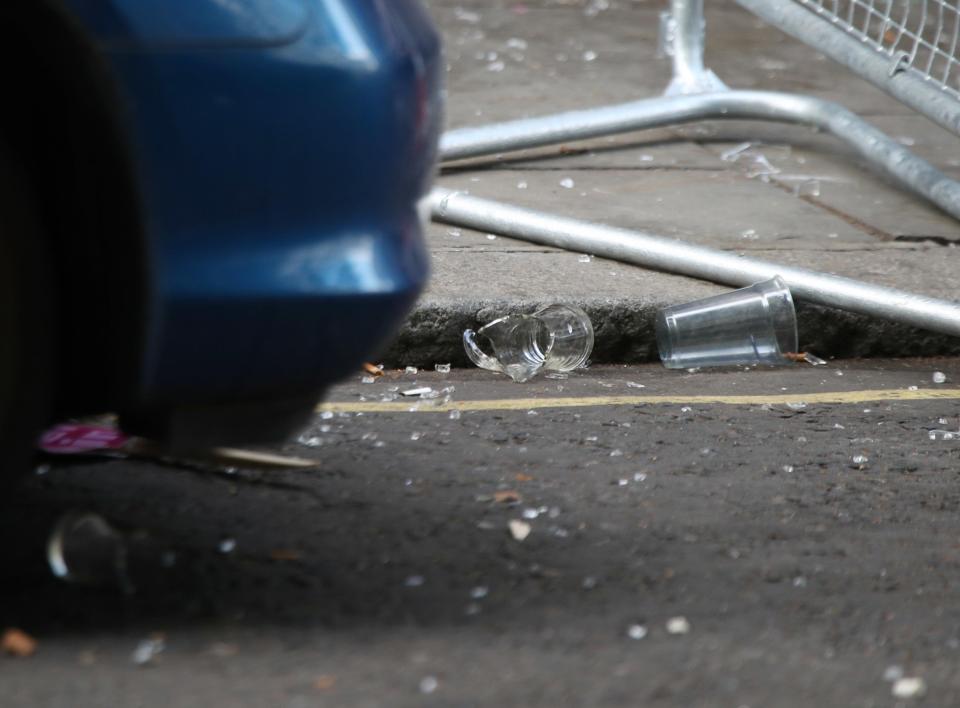  A broken glass is pictured at the scene