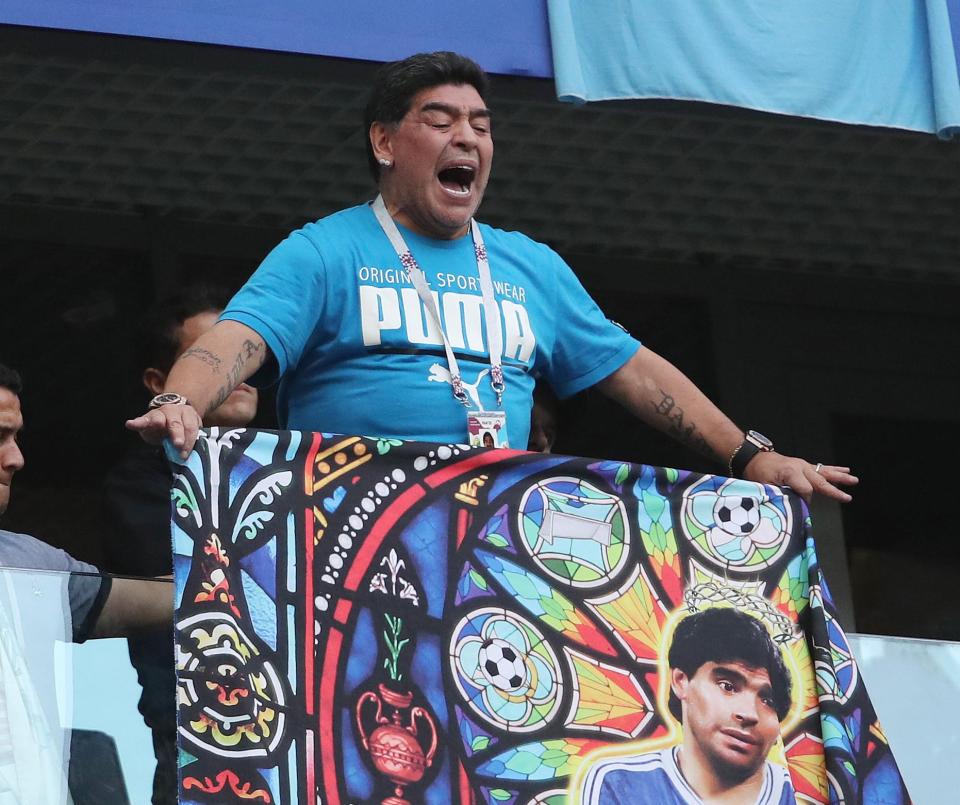  Diego Maradona screams and unfurls a picture of himself during Argentina vs Nigeria