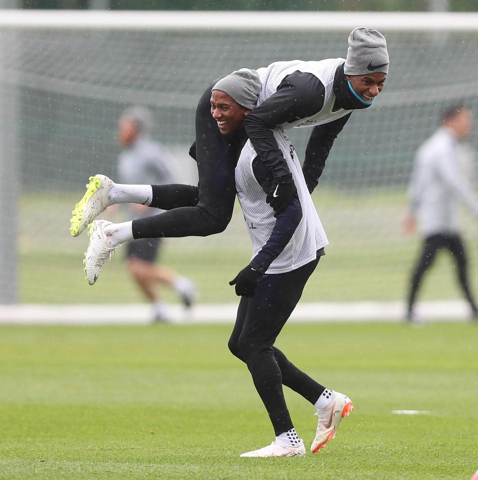  Ashley Young lifts Marcus Rashford up during England training