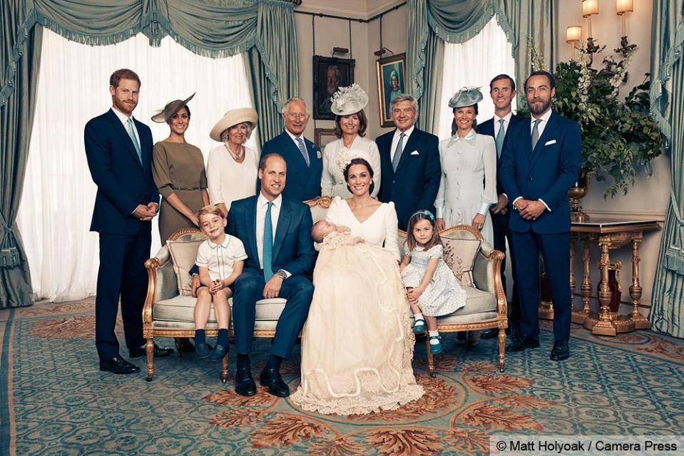  Proud grandparents Carole Middleton and Prince Charles took centre stage of the shot looking over two generations on the sofa - with the Queen's portrait taking pride of place on the wall