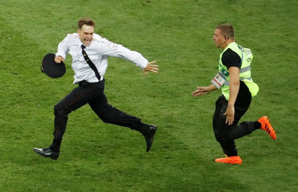  Stewards were quick to tackle the pitch invaders as they sent a message out to Russian president Vladimir Putin