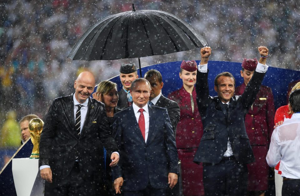  Vladimir Putin came prepared while Gianni Infantino, left, and Emmanuel Macron, right, got soaked