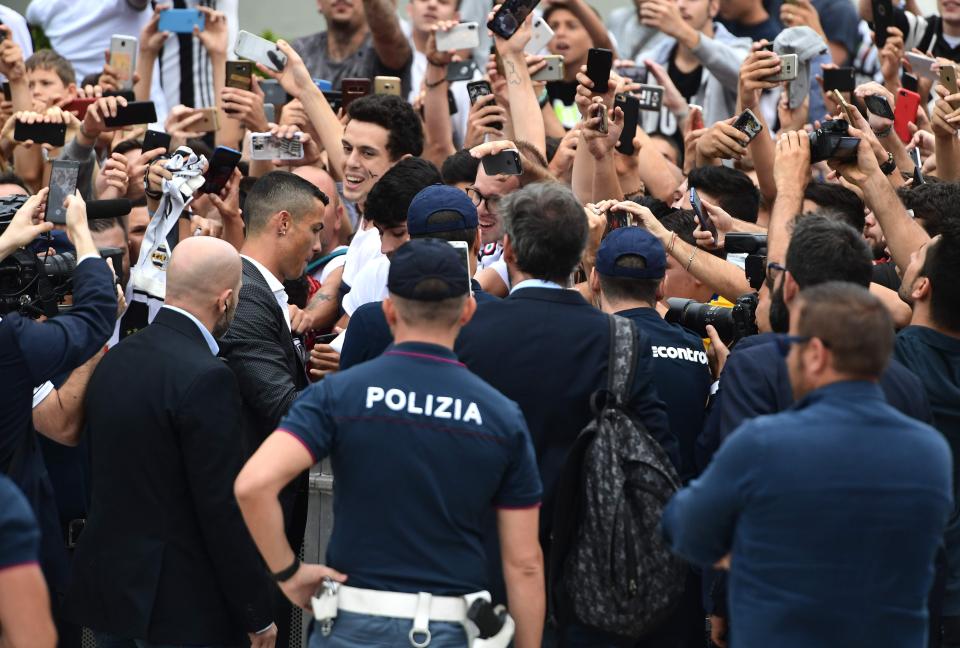  Police had to help out with crowd control as Ronaldo signed autographs on shirts and posed for selfies