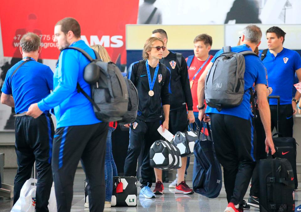  Luka Modric, wearing his silver medal, will return to Zagreb from Russia on Monday afternoon