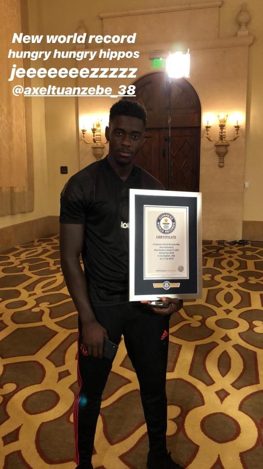  Axel Tuanzebe holds up an official Guinness World Record certificate