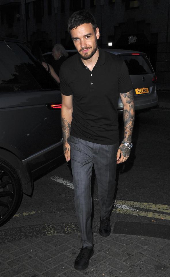  Liam looked dapper in grey trousers and a black top