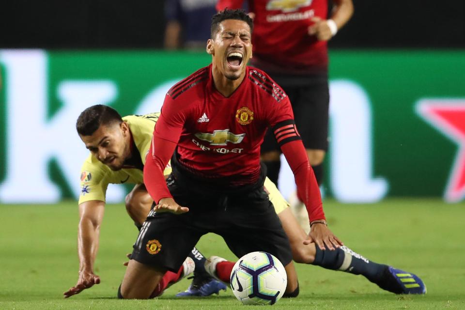  Chris Smalling takes a tumble after being challenged