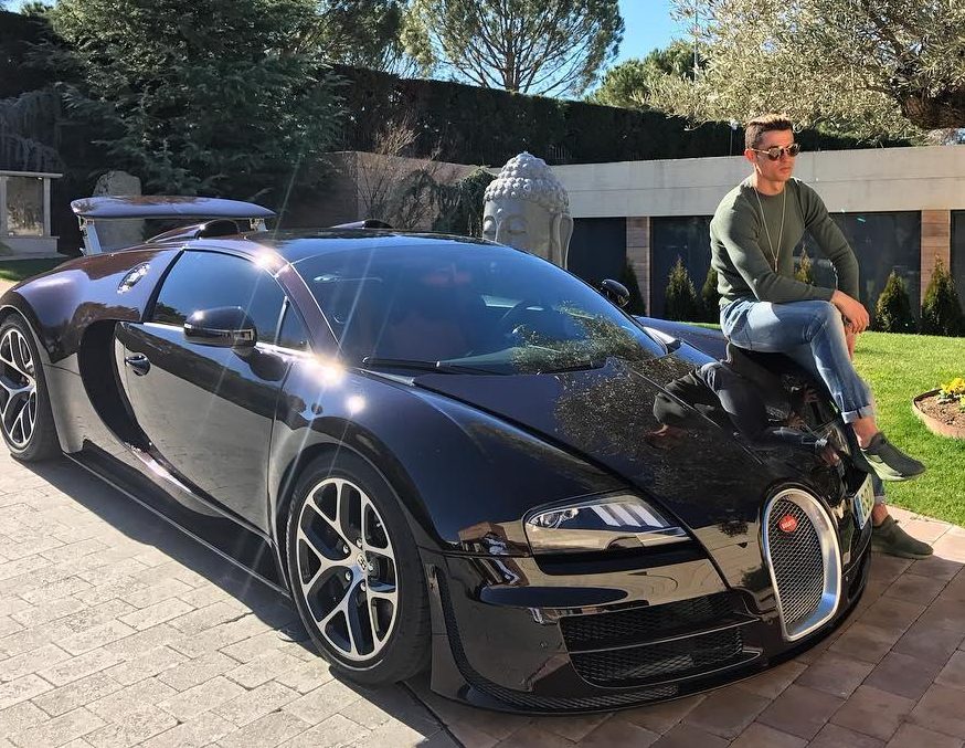  Ronaldo poses outside his former Madrid home on his $2.1m Bugatti Veyron