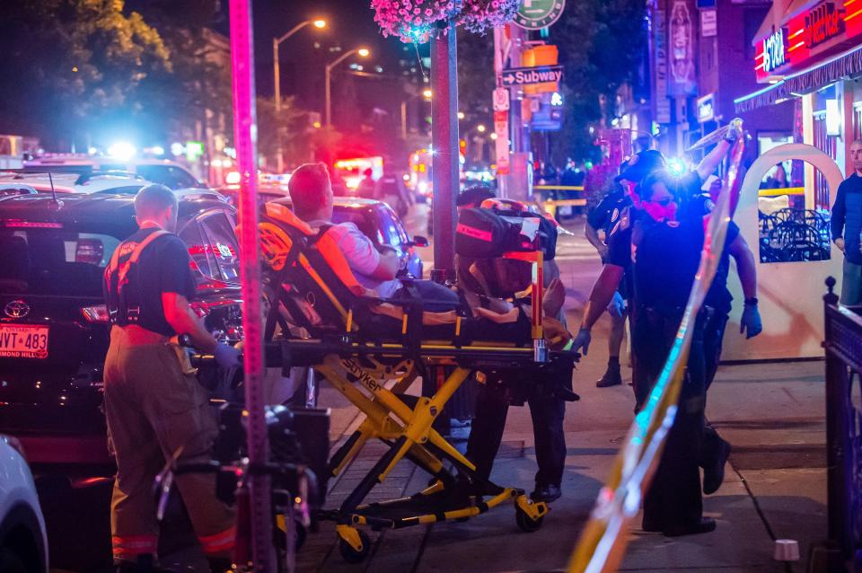  Emergency services help an injured man after the Toronto shooting yesterday