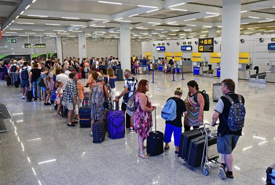  Passengers wait in line in front of Ryanair's desks during the first day of strike of the cabin crew strike at the Palma de Majorca airport