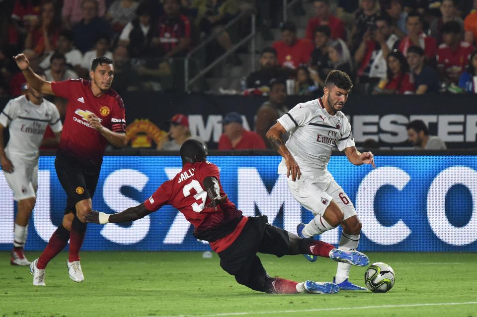  Eric Bailly slides in to win the ball from Patrick Cutrone