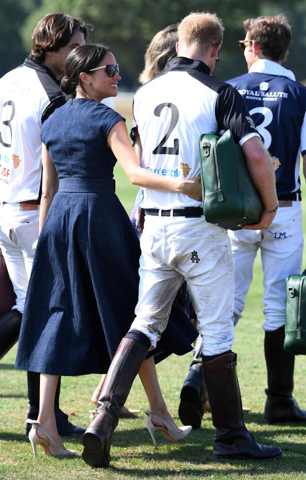  Beaming Meghan puts her arm around exhausted Harry as they walk together