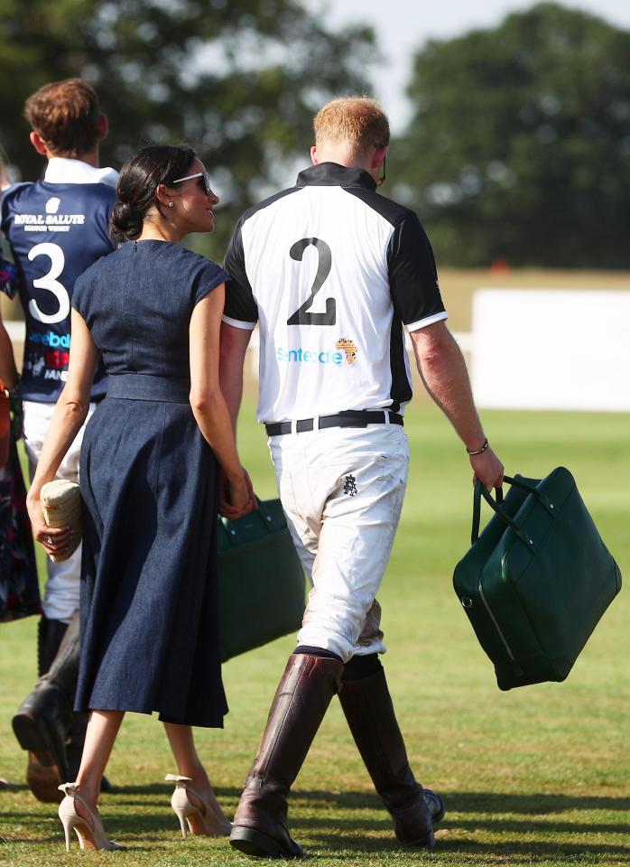  The couple hold hands as they march off the pitch together