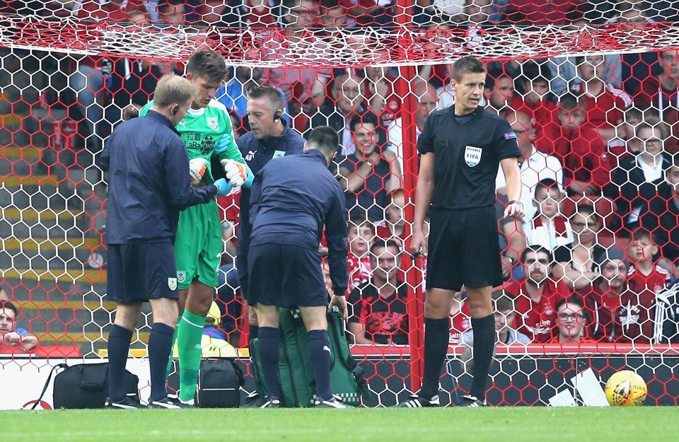  Burnley medics check on keeper Nick Pope after his collision