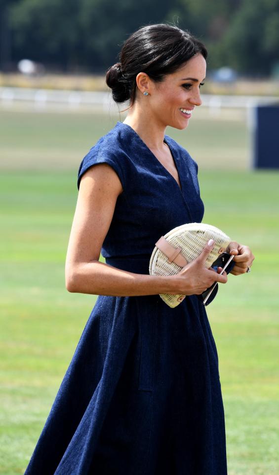  Meghan Markle has nailed smart summer dressing with her midi dress and straw clutch combo