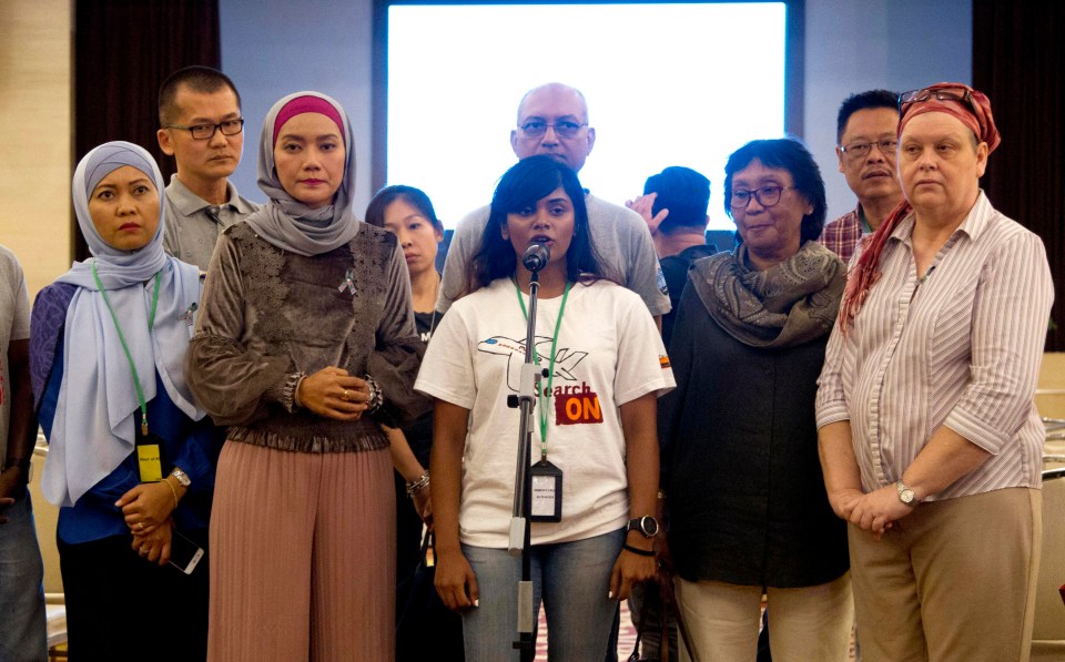 Relatives of passengers on board the missing flight speak to reporters after reading the Malaysian government’s report