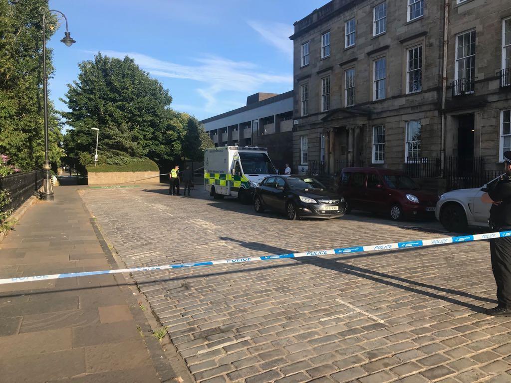  Police sealed off the area outside Glasgow's Carlton Place where a lawyer was slashed with a knife