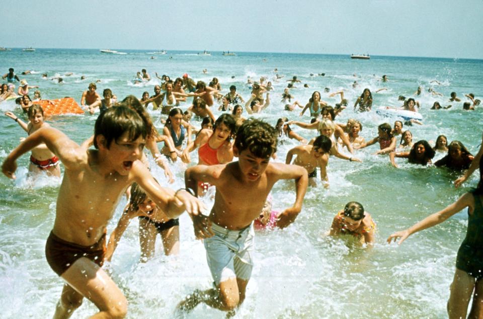  People run from the sea in terror in a scene from the iconic 1975 movie