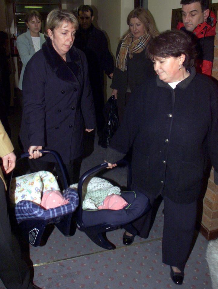  Police and social services pictured removing the babies from their adoptive parents Alan and Judith Kilshaw in 2001