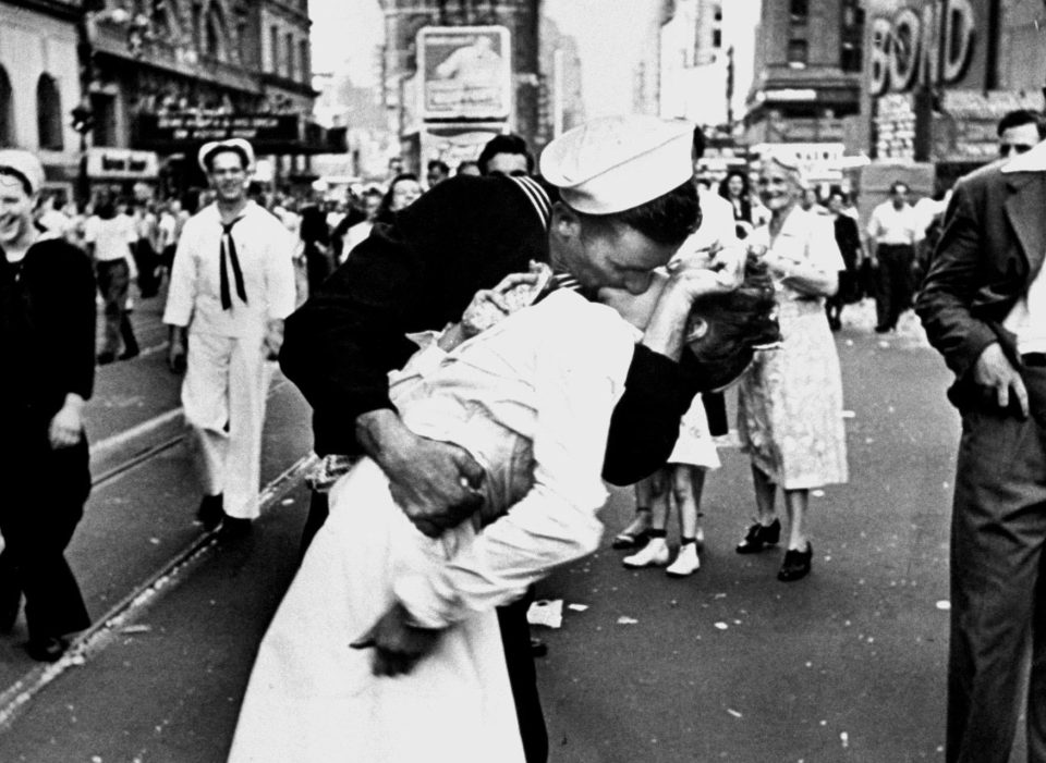  A jubilant American sailor clutching a white-uniformed nurse in a back-bending, passionate kiss as he vents his joy while thousands jam Times Square to celebrate the long awaited-victory over Japan