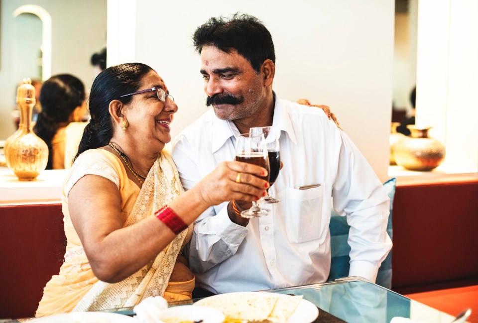 An Indian couple enjoy a drink together