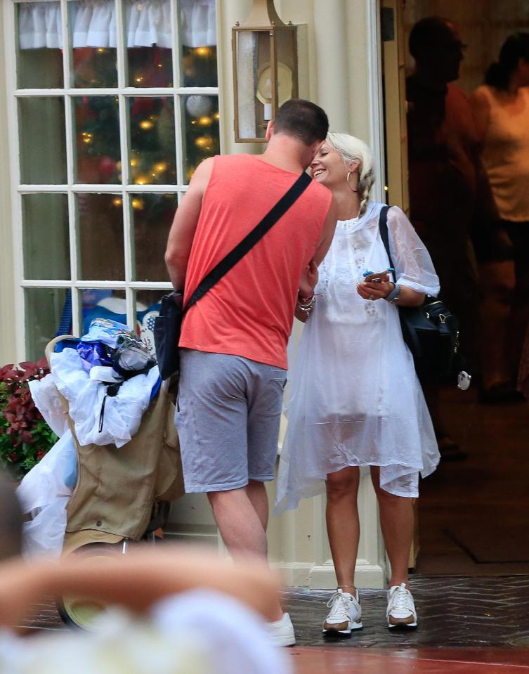  Jo looked stunning in a white dress - even if she did have to cover it with a mac