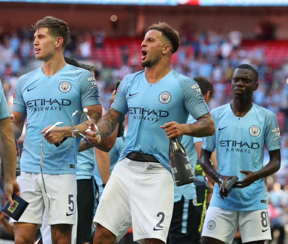  Kyle Walker and John Stones toast their success after they helped keep the Chelsea attack quiet at Wembley