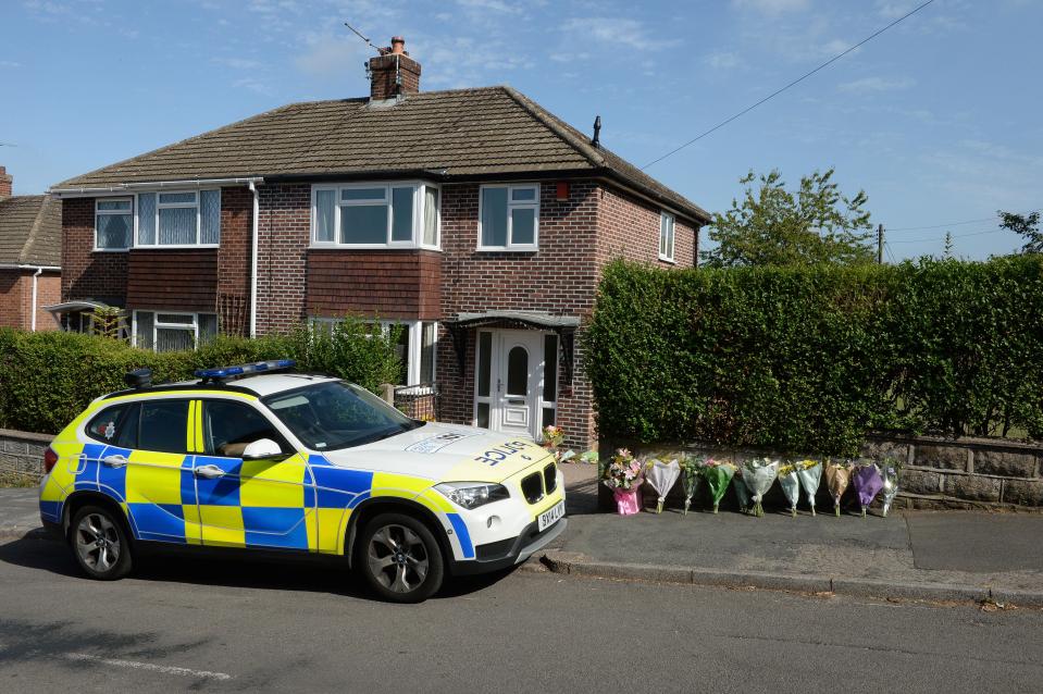  Floral tributes and a police car outside the home of murder victim Samantha Eastwood