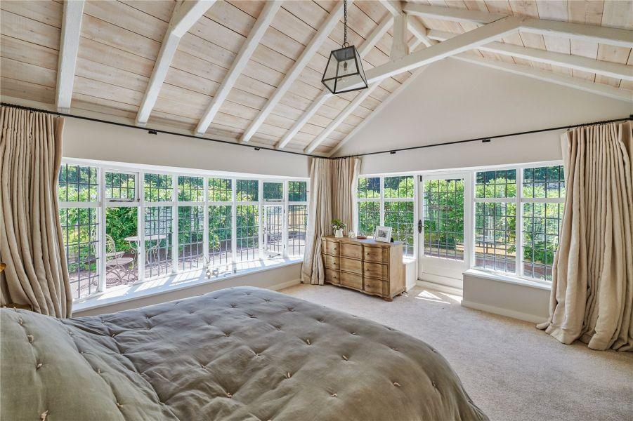 Windows stretch across the walls in the master bedroom