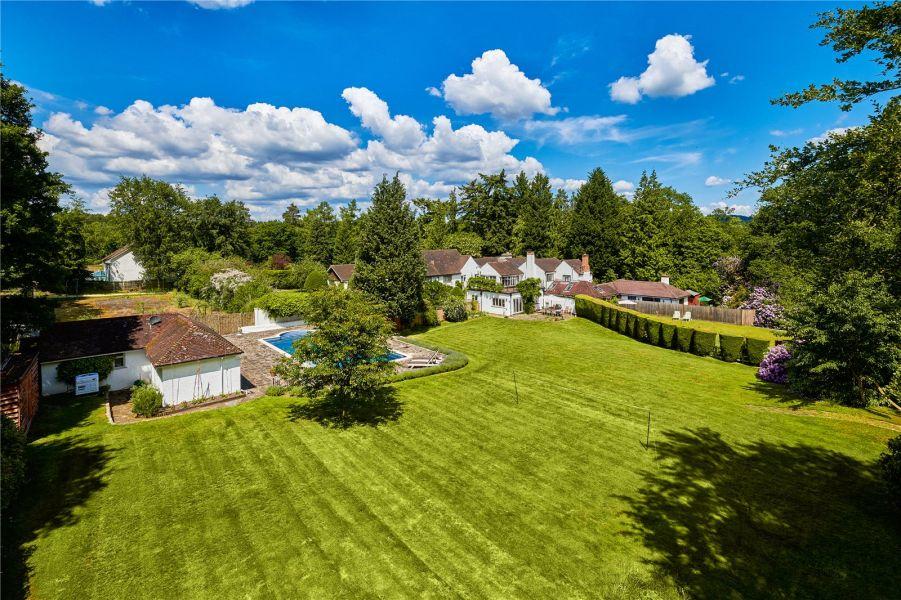 The master bedroom boasts glorious views across the rolling gardens