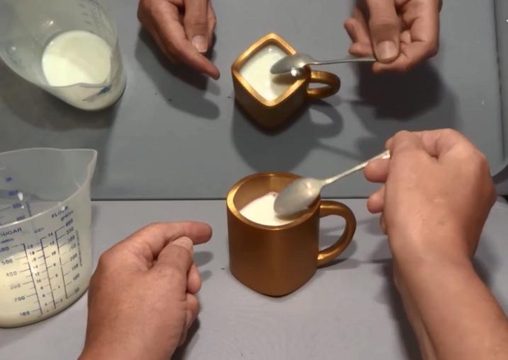  He pours milk in the mug to demonstrate it is a genuine experiment