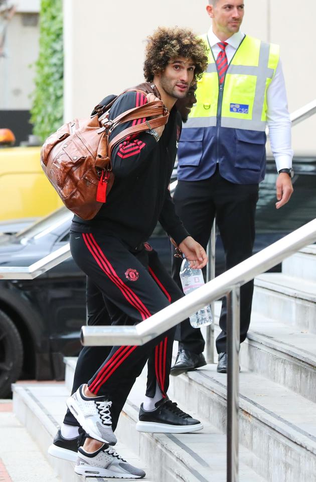  Marouane Fellaini lugged a bag into the hotel as he prepared for the sit-down chat