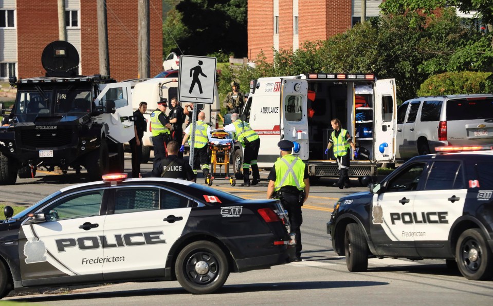 Paramedics prepare a stretcher following the shooting in Fredericton