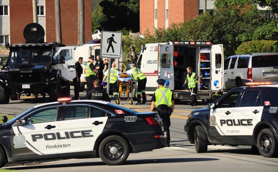  Paramedics prepare a stretcher following the shooting in Fredericton