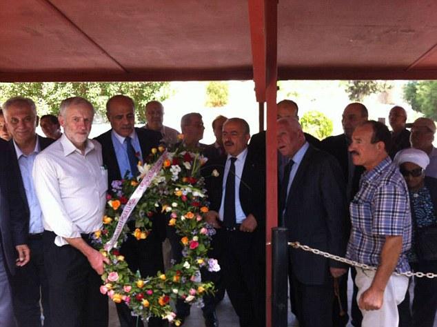  This picture shows Jeremy Corbyn holding a wreath as he reportedly stands beside the grave of terrorists who killed Israeli Olympic athletes