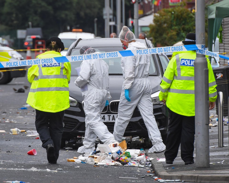 Police and forensic officers at the scene of the shootings in Manchester